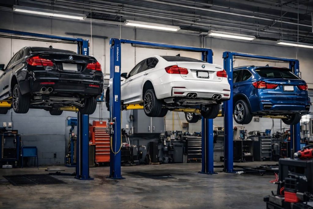 BMW vehicles on lifts in European repair shop in Grand Haven