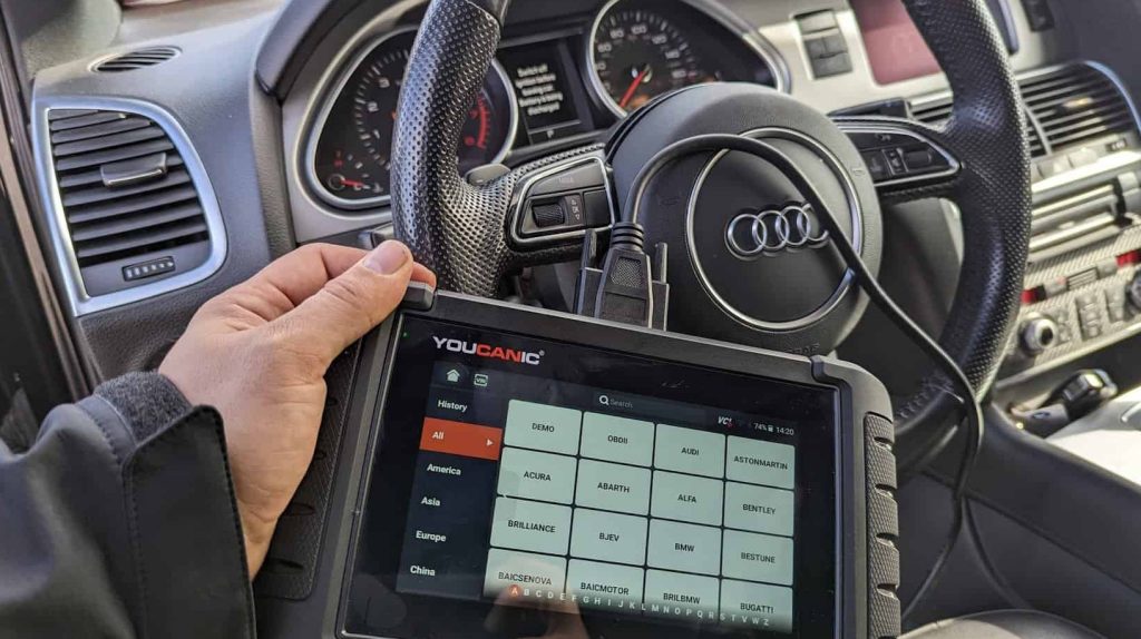 one of our certified german mechanic using an OBD2 scanner on an Audi vehicle for the determine what the issue is
